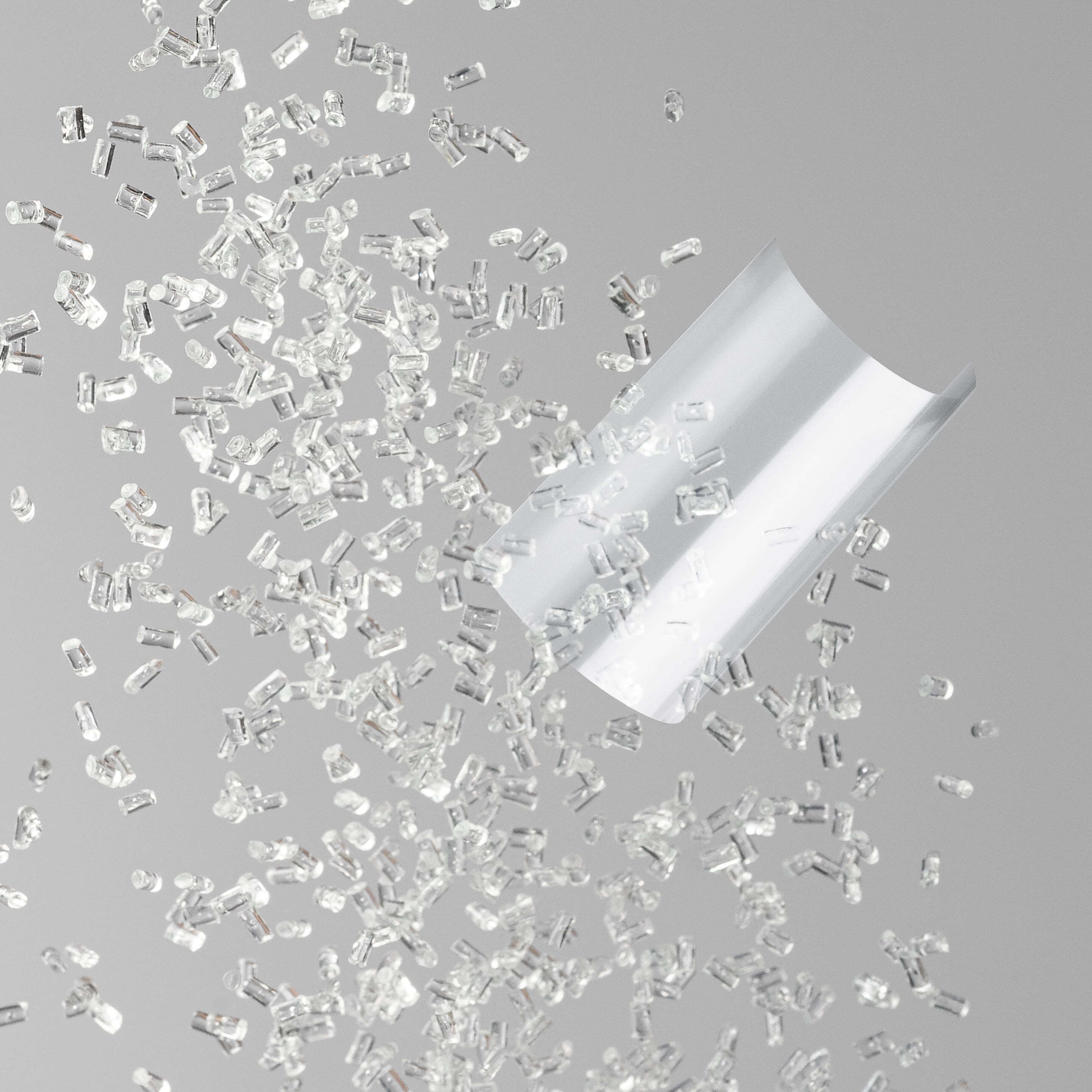 COP Pellets and film colliding in the air on a grey background