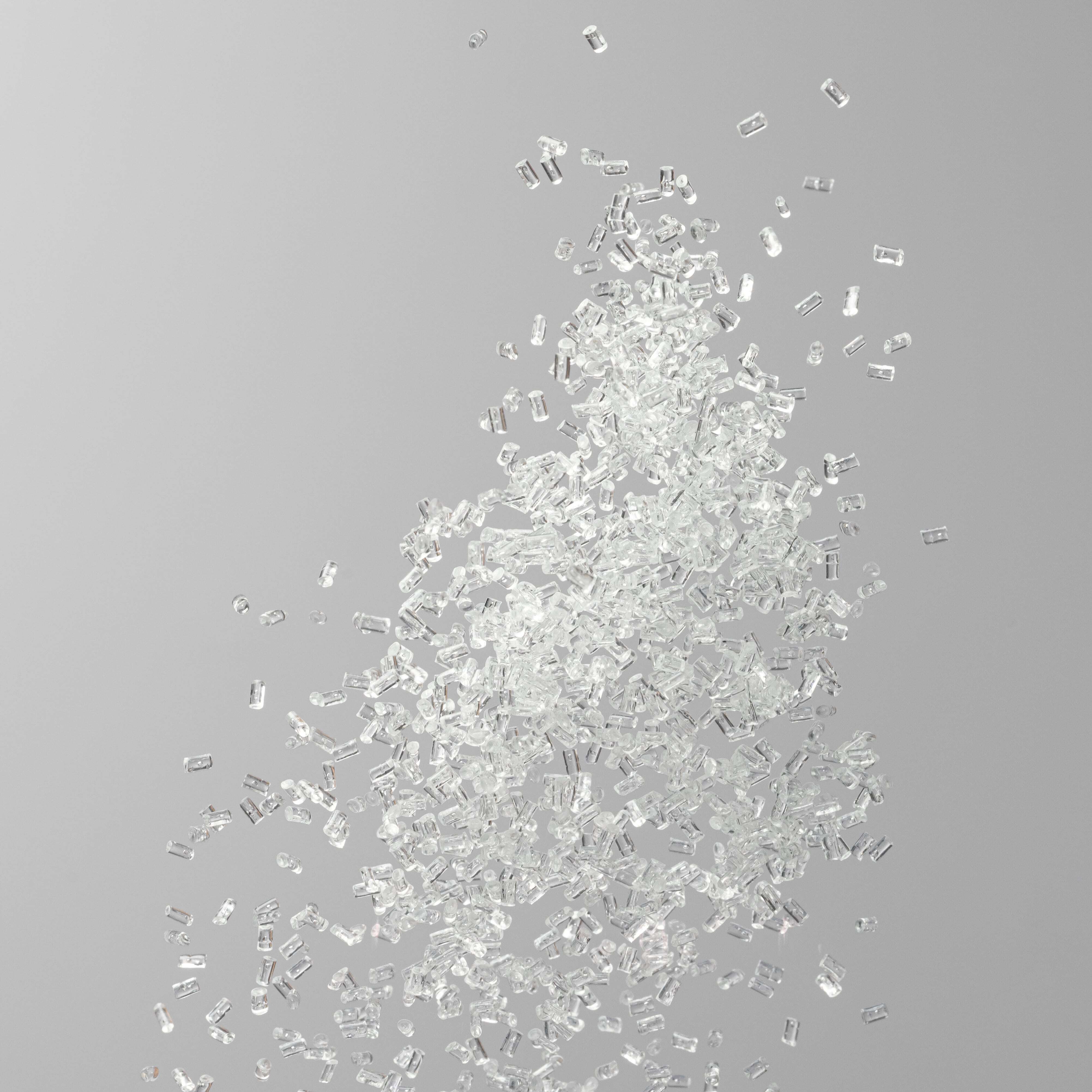 Zeon COP Pellets falling on a grey background