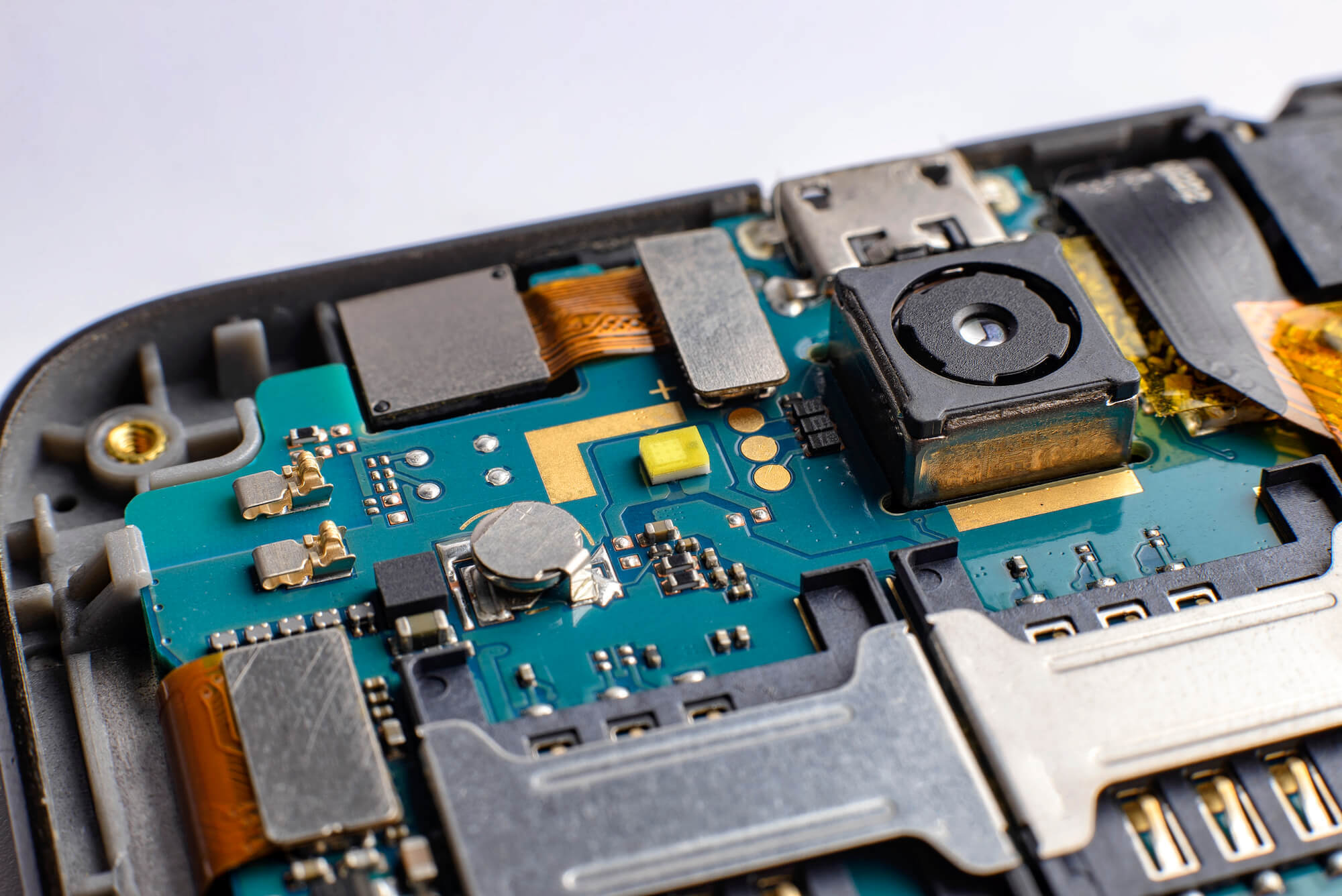Close-up of a phone's internal semiconductors connected to a phone camera