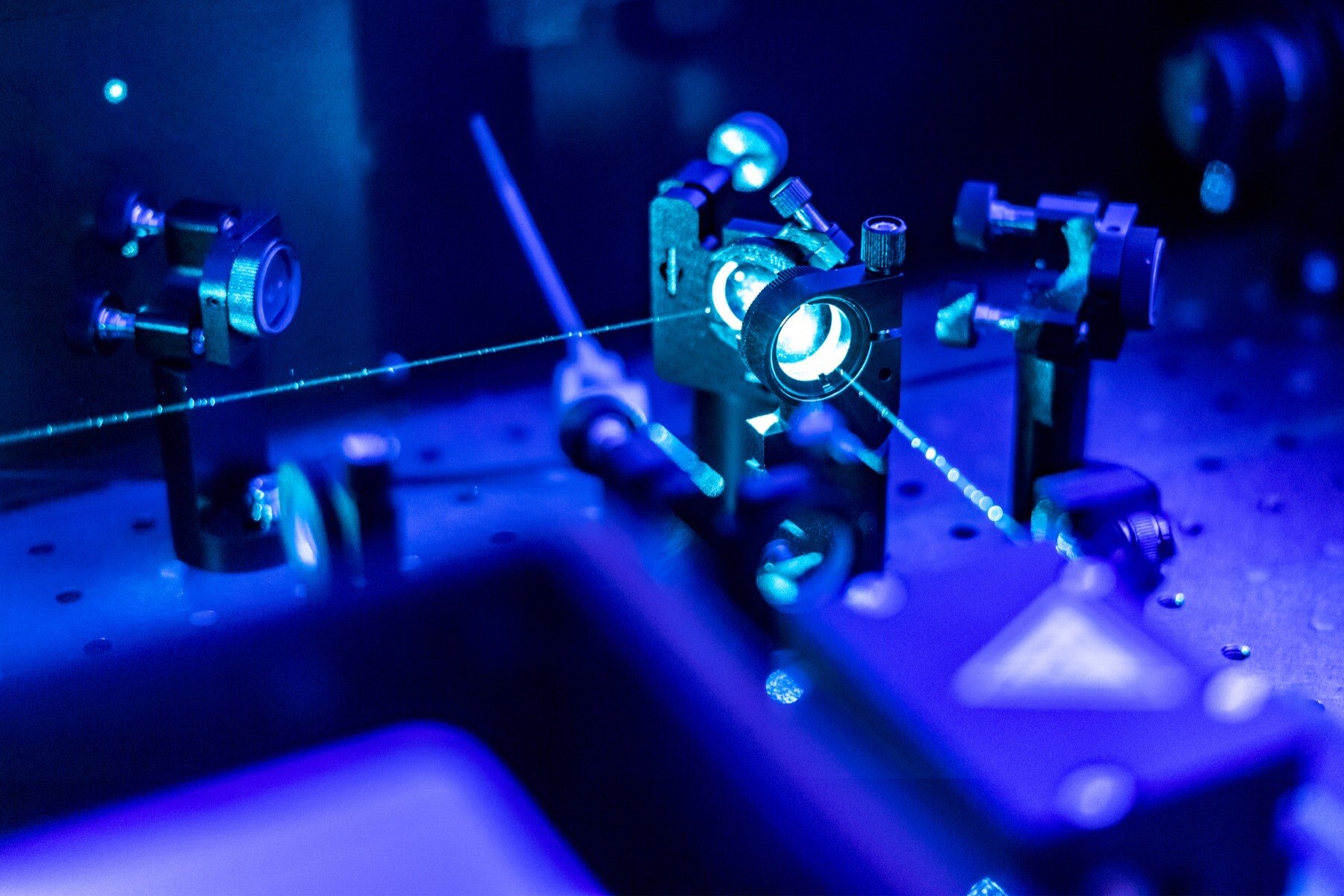 Laser reflected on an optic table in a quantum laboratory